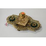 A Victorian style brass desk stand, of shaped rectangular form, having pierced floral decoration and