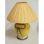 A large modern table lamp, of baluster form, on a yellow ground with blue ropetwist decoration,