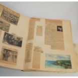 A mid-20th century scrap album and contents, to include press cuttings, watercolours, photographs,