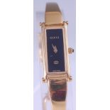 A Gucci 1500 lady's gilt metal cased quartz wristwatch, having a signed black dial, back cover