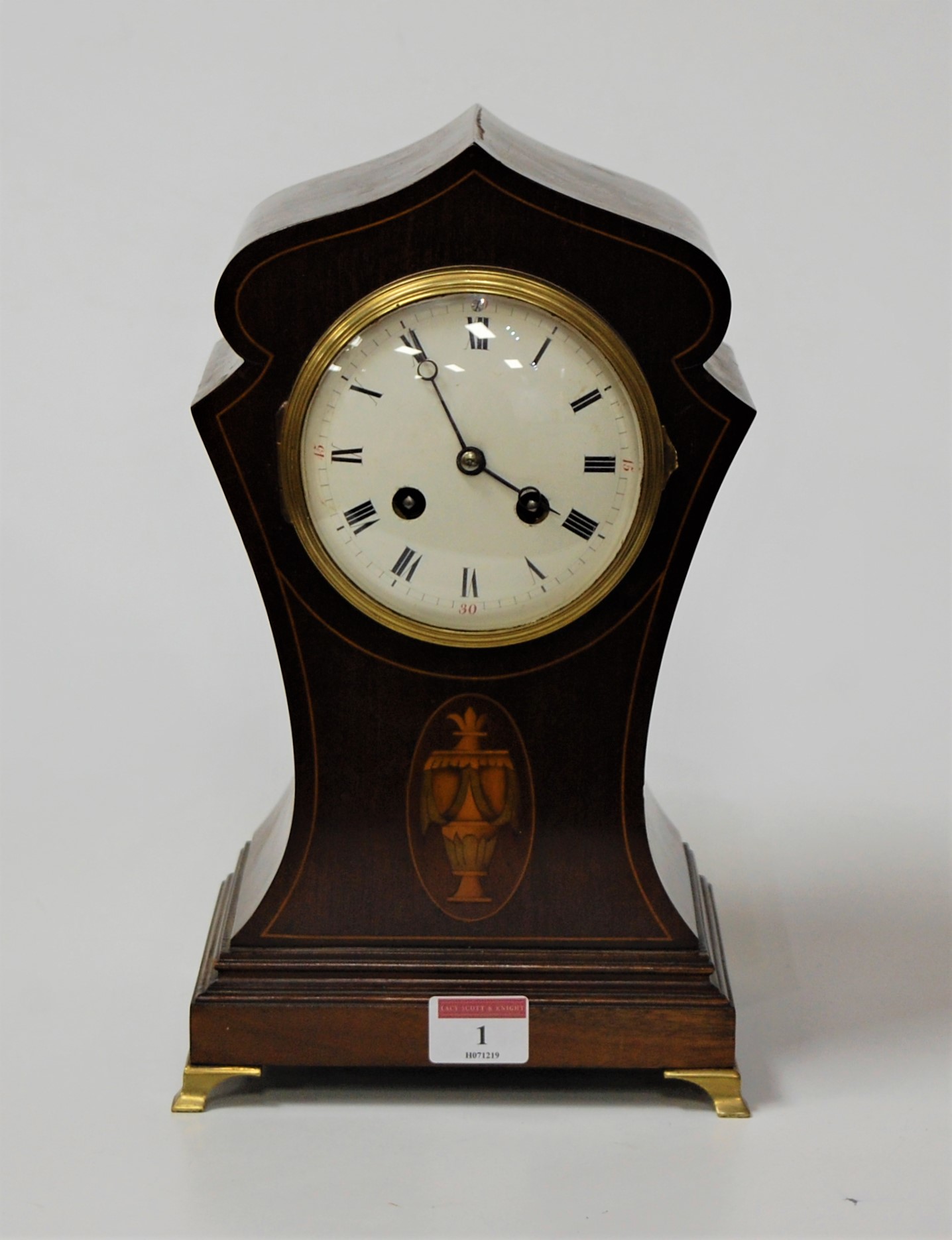 An Edwardian mahogany, box wood strung and satinwood inlaid lancet shaped mantel clock having a