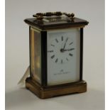 A mid-20th century lacquered brass cased carriage clock, the enamelled dial signed Matthew Norman,