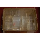 A box of assorted perspex display stands