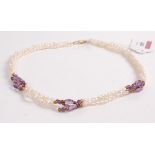 A cultured seed pearl and amethyst set triple string choker