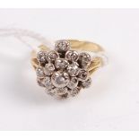 An 18ct gold diamond cluster ring in a tiered surround of 20 old cut diamonds, 5.3g, size K