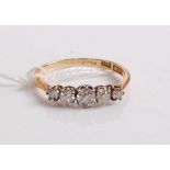 An 18ct gold and platinum diamond five stone ring, the graduated round cut diamonds in a line