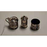 A George V silver three piece cruet each of pierced cylindrical form to include mustard, salt, and