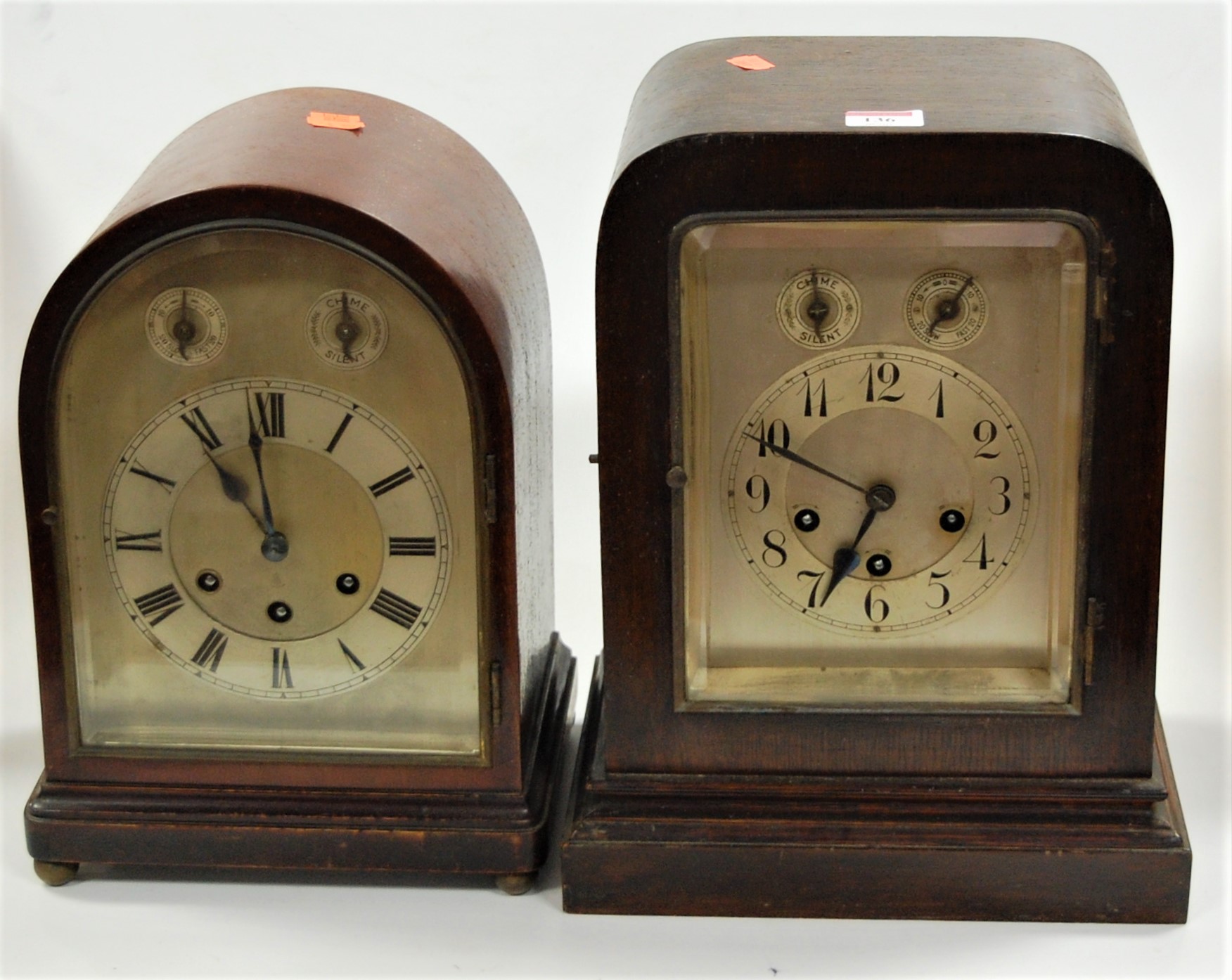 A 1920s mahogany dome-top mantel clock, having arched silvered dial with Roman numerals, chiming