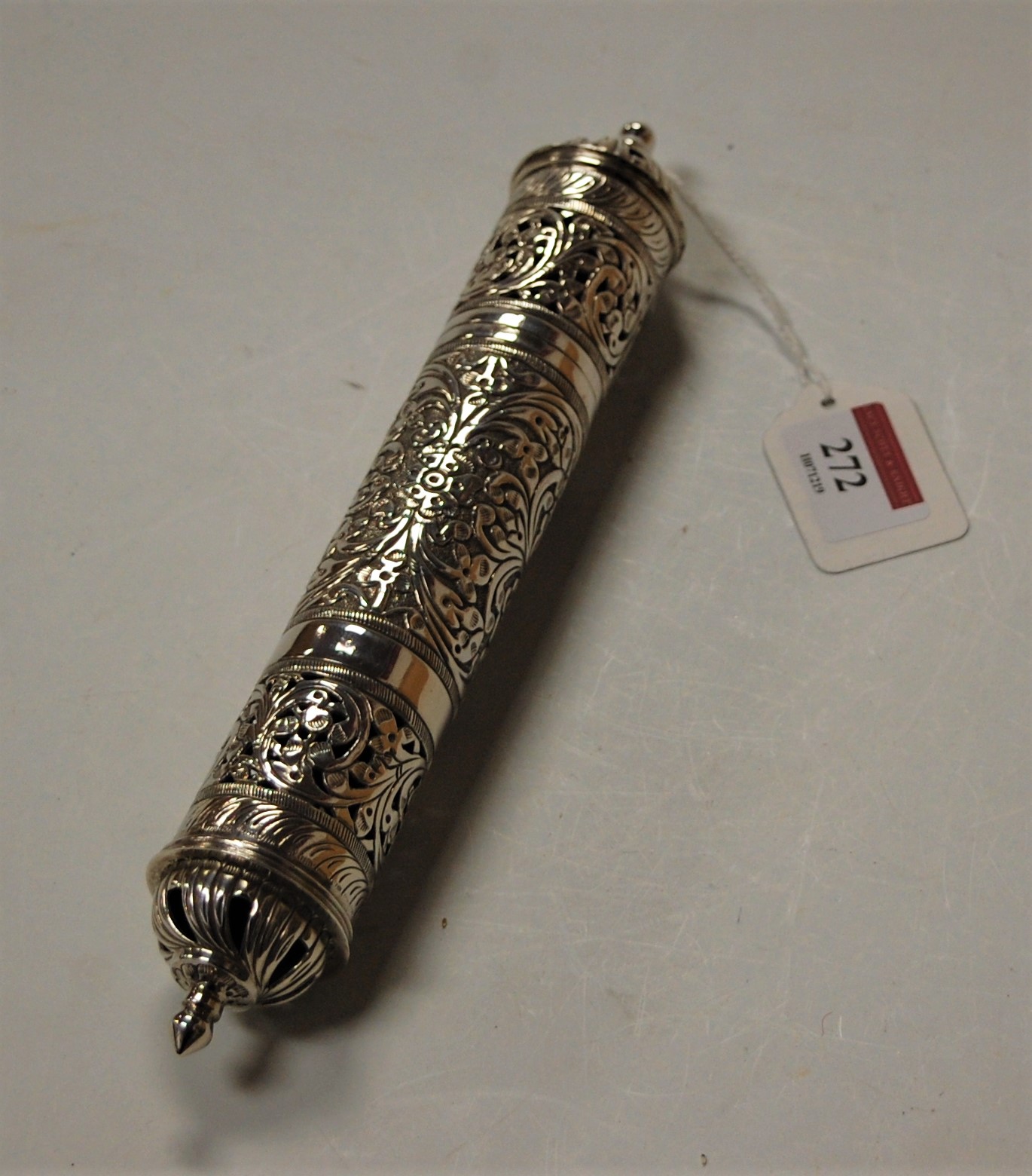 A 20th century continental silver scroll sleeve of pierced cylindrical form having all over