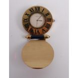 A Must de Cartier of Paris gilt brass travel clock, having quartz movement and cabochon sapphire set