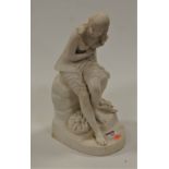 A Victorian parian figure of a lady, in seated pose with a bundle at her feet, having raised diamond