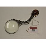 A continental white metal magnifying glass, the stem with openwork decoration and the terminal