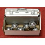 A cased boules set, together with another