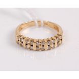 A contemporary 18ct gold diamond half eternity ring, arranged as five groups of four small brilliant