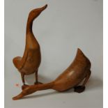 A pair of carved beech figures of ducks, largest height 50cm