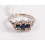 A contemporary 18ct white gold sapphire and diamond dress ring arranged as three baguette