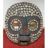 A large souvenir tribal wall mask having seashell and beadwork decoration 46cm