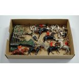 A collection of Britains painted lead figures of huntsmen and hounds; together with scenery etc