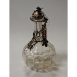 A Victorian glass decanter of mallet shape, the silver collar and cover in the form of fruiting