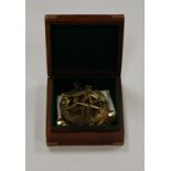 A reproduction brass sundial in fitted case