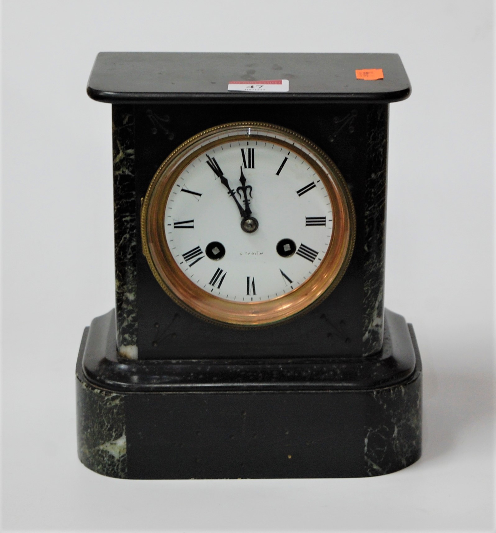 A late 19th century marble cased mantel clock having a circular enamel dial with Roman numerals