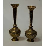 A pair of Indian brass vases, each having a flared rim to a slender tapering neck and bulbous