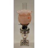 A 20th century oil lamp, having pink opalescent frilled glass shade, the silver plated base in the
