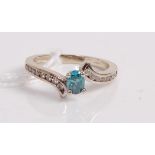 A contemporary 14ct white gold, topaz and diamond set dress ring, the four claw set oval cut topaz