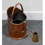 An early 20th century copper coal scuttle, together with a brass mounted leather belt, and a small