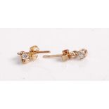 A pair of yellow metal diamond ear studs, each set with a single round cut diamond weighing approx