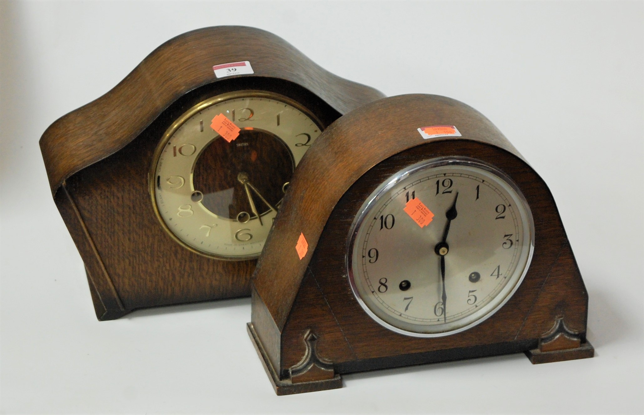 A 1950s Smiths oak cased mantel clock, the circular dial with gilt Arabic numerals, and chiming