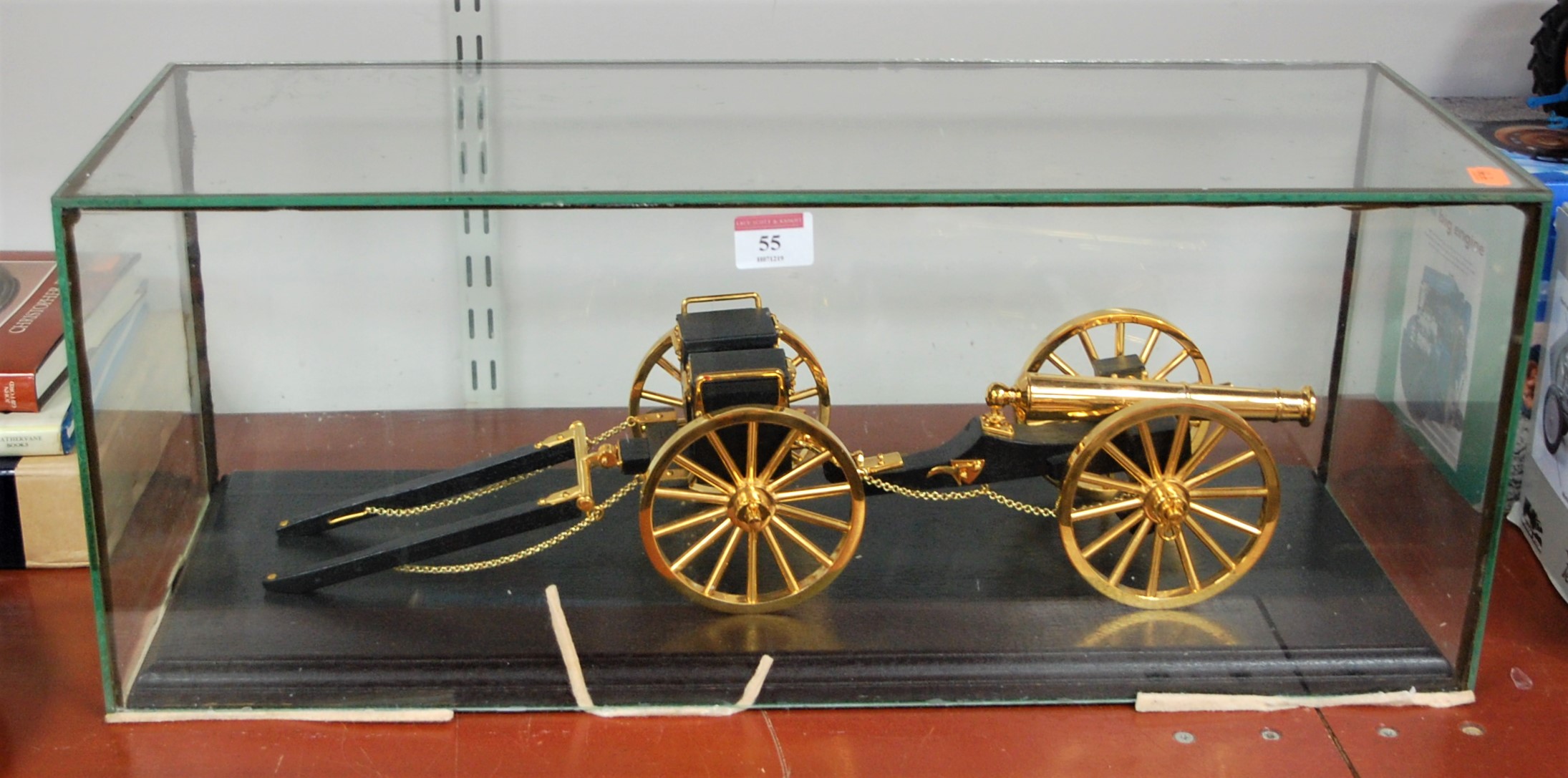 A large hand built gold plated model of an artillery canon within glazed display case, case