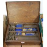 A fitted wooden case containing various Meccano parts