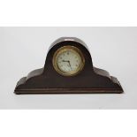 A 1950s oak cased mantel clock having a silvered dial with Arabic numerals