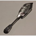 A Victorian silver fish slice, having a pierced blade and monogrammed terminal, in the Fiddle