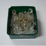 A collection of Victorian and later glass scent bottles, each having silver collar or cap