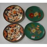 A pair of Watcombe Torquay Pottery terracotta plates, each hand-painted with flowers, impressed mark