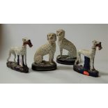 A pair of 19th century Staffordshire figures, each in the form of a greyhound with rabbit in