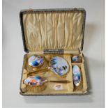 A 1950s hand-painted and enamelled lady's dressing table set, to include hand mirror, clothes brush,