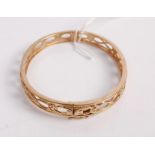 A modern 9ct gold openwork hinge bangle, 13.3g, w.69mm