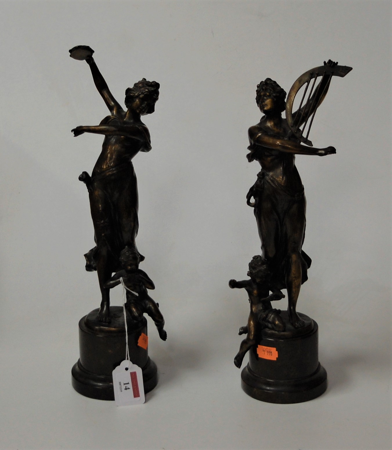 A pair of reproduction bronze figures of female musicians each in standing pose with instrument in