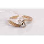 A 9ct gold diamond crossover ring, the two claw set brilliants each weighing approx 0.08 carats