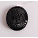 A Victorian carved Whitby jet brooch depicting profile portrait of a maiden, 52 x 47mm