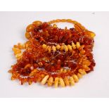 Assorted clear and orange amber beads, and a single butterscotch amber pendant weighing 8.7g