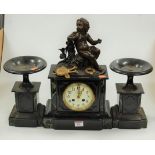 A late 19th century black slate and marble cased mantel clock, having an enamelled dial with