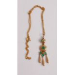 A pinchbeck and green stone set pendant, on yellow metal finelink neck chain, chain tests as