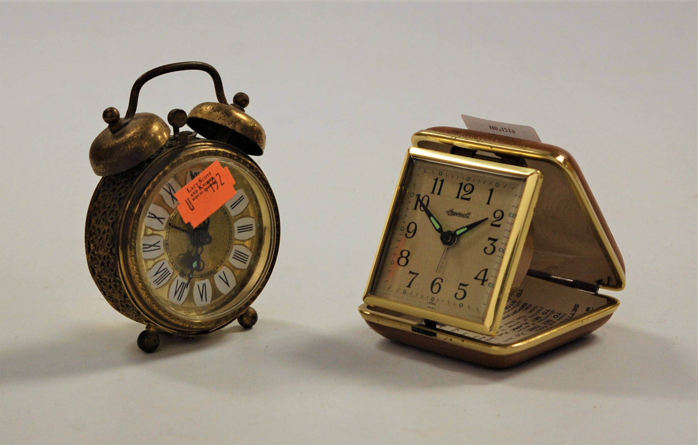 An Ingersoll travel clock; together with a brass cased alarm clock (2)