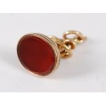 A yellow metal and carnelian set fob pendant, having plain carnelian set matrix, in engraved