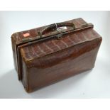 A circa 1900 gent's crocodile skin travel case, contents to include matched silver topped jars,