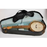 A Keech ukulele/banjo No. 127 in fitted case